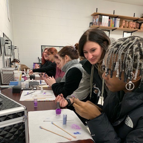 Gina Horn KACC Alumnus, now salon owner, teaching nail design techniques to students.